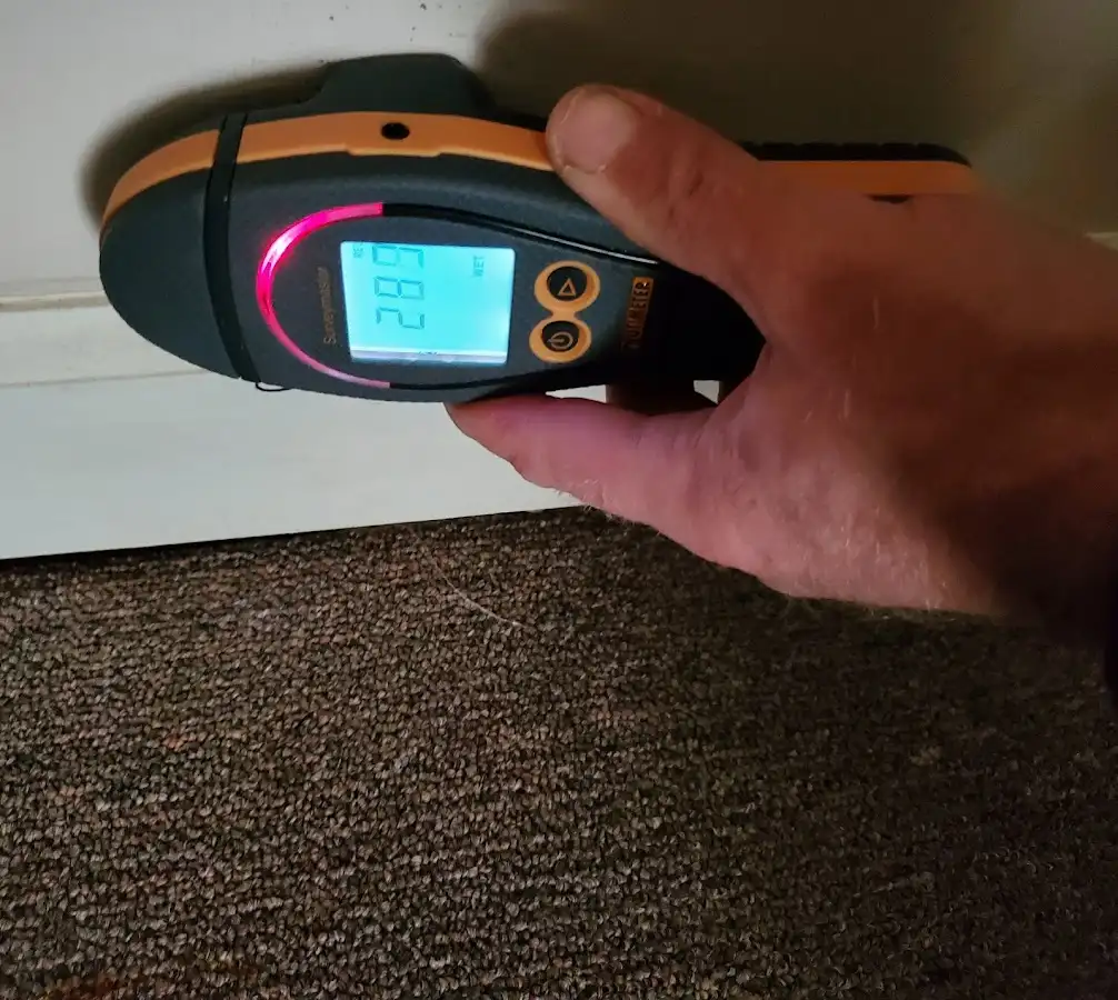 Moisture detection at baseboard during Storm Damage Restoration in Swanton